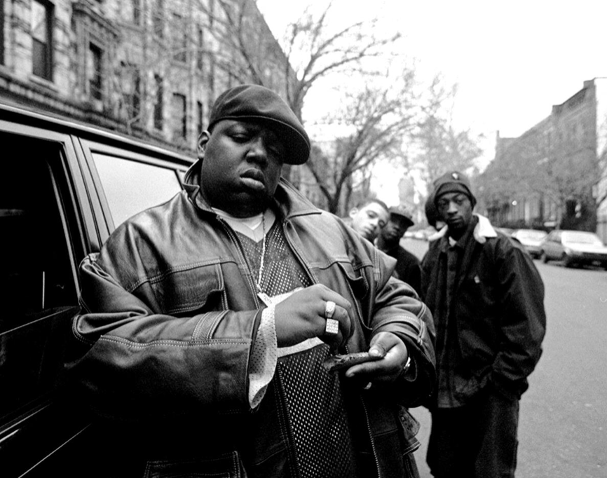 Rapper Notorious B.I.G., born Christopher Wallace, outside his mother’s house in Brooklyn, 1995. A new biography by Justin Tinsley contextualizes his life and death. (Clarence Davis / NY Daily News Archive via Getty Images)